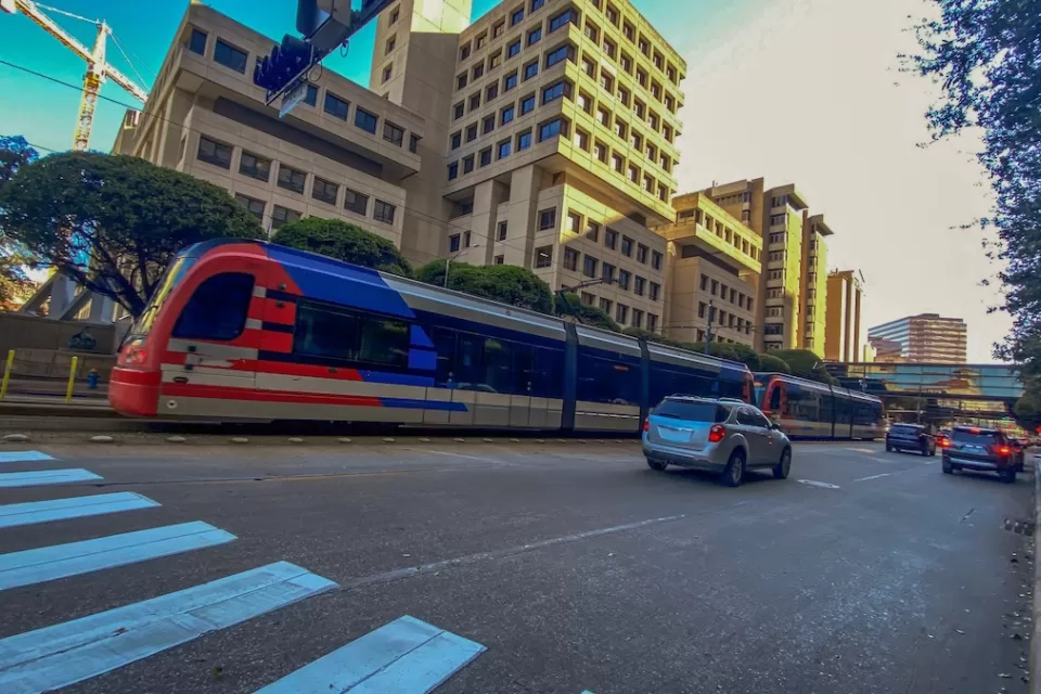 Blue and red light rail train in downtown Houston, Texas.